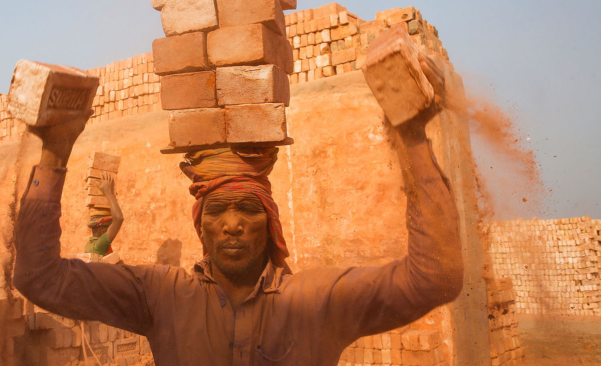 A worker working in the scorching heat at a brick factory at Ashulia, on the outskirts of Dhaka. A recent photo by Hasan Raja