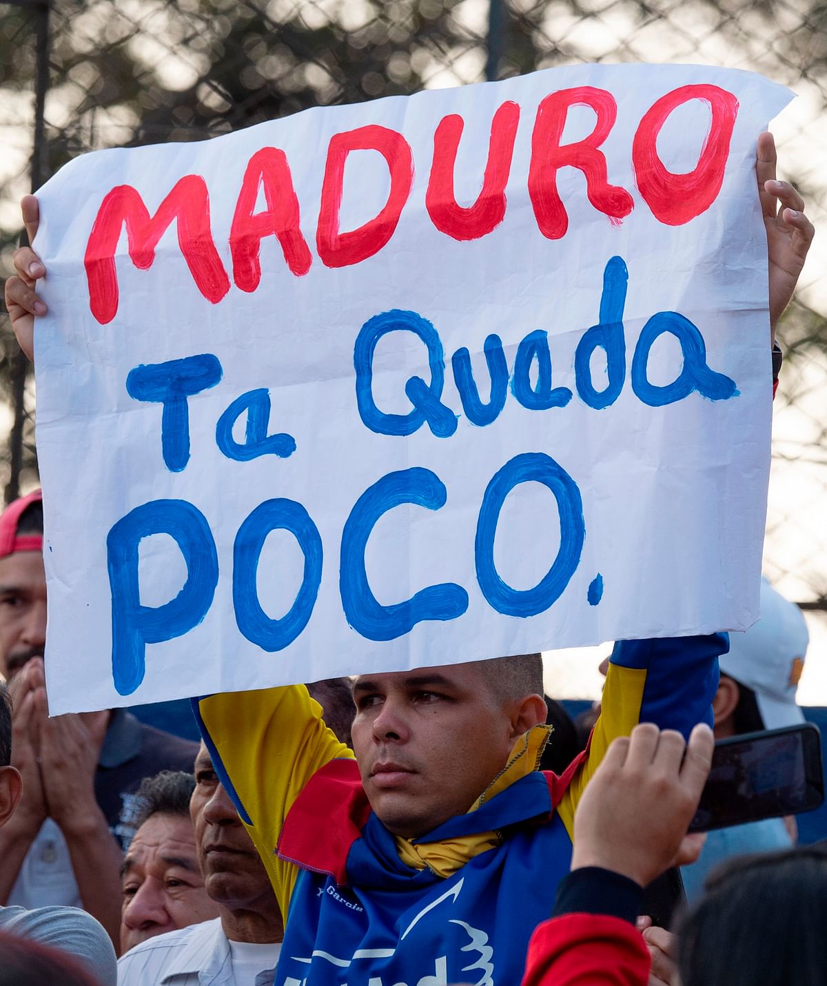 A Venezuelan man living in Peru holds a placard that read `Maduro you are running out of time` as he takes part in a rally in support of Venezualan opposition leader and self-declared acting president Juan Guaido in Lima on 1 May 2019. Photo: AFP