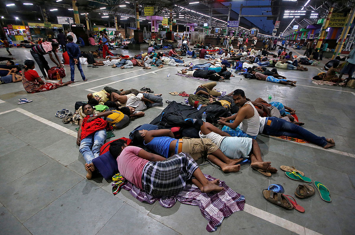 Stranded passengers rest inside a railways station after trains between Kolkata and Odisha were cancelled ahead of Cyclone Fani, in Kolkata, India, on 3 May 2019. Reuters
