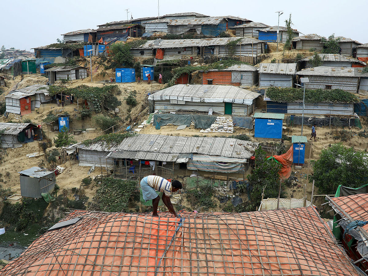A Rohingya refugee repairs the roof of his shelter at the Balukhali refugee camp in Cox`s Bazar, Bangladesh, on 5 March 2019. Reuters File Photo