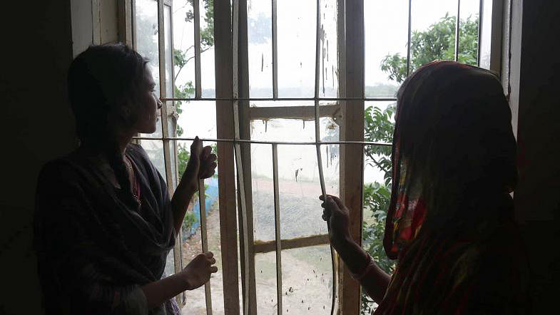Two teenage girls waiting for fair weather in a rescue centre in Khulna`s Dacope upazila on 4 May, 2019. Photo: Saddam Hossain