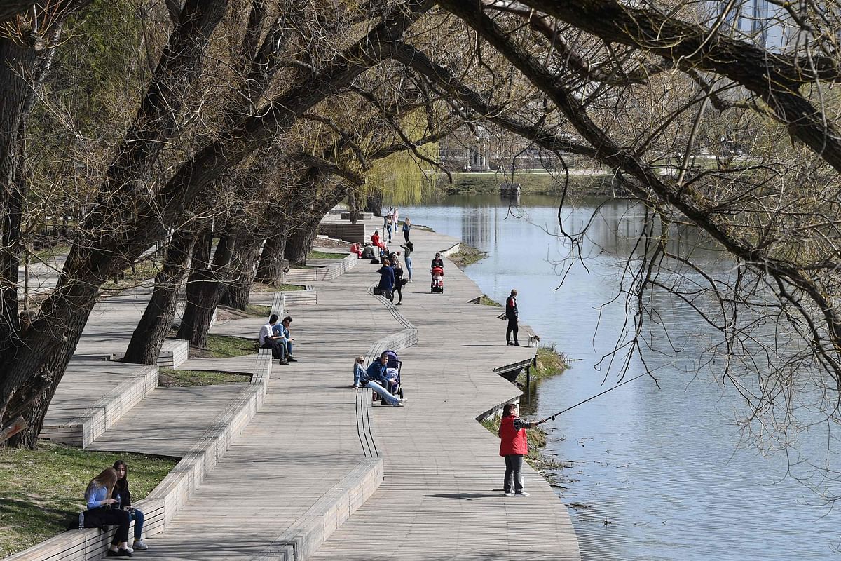 People rest in the park on the renovated embankment of the Vezelka river in the Russian city of Belgorod, some 700 km south of Moscow, on 10 April 2019. For decades, the banks of the river flowing through the Russian city of Belgorod were in a sorry state of disrepair. Photo: AFP