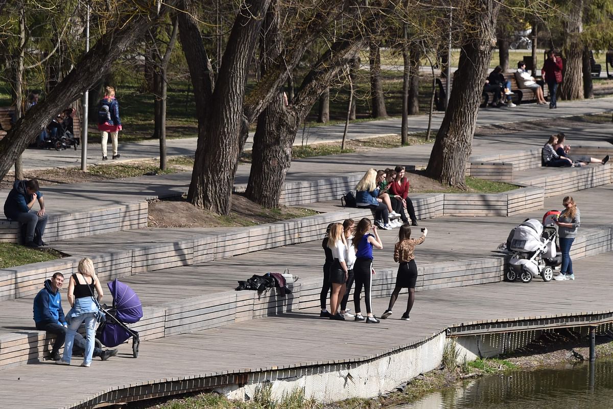 People rest in the park on the renovated embankment of the Vezelka river in the Russian city of Belgorod, some 700 km south of Moscow, on 10 April 2019. For decades, the banks of the river flowing through the Russian city of Belgorod were in a sorry state of disrepair. Photo: AFP