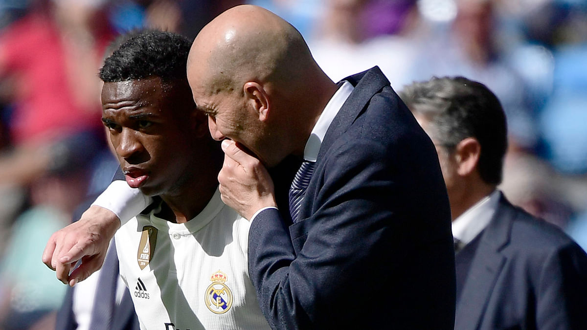 Real Madrid`s French coach Zinedine Zidane (R) talks to Real Madrid`s Brazilian forward Vinicius Junior during the Spanish league football match between Real Madrid CF and Villarreal CF at the Santiago Bernabeu stadium in Madrid on 5 May 2019. Photo: AFP
