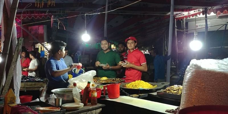 People eat street food in Dhaka on 18 April, 2019. Photo: Jung Da-min