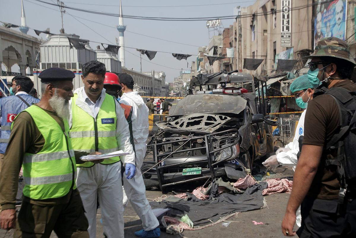 Security officials and members of a bomb disposal team survey the site after a blast in Lahore, Pakistan on 8 May 2019. Photo: Reuters