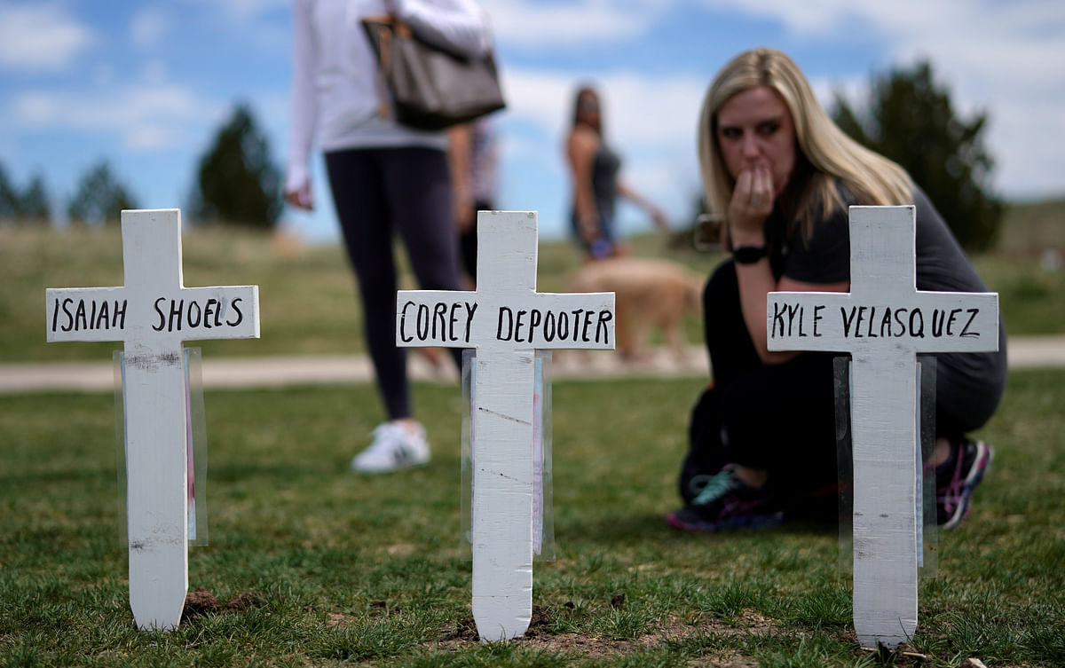 Cassanda Sadusky, survivor of the attack, looks at a line of crosses commemorating those killed in the Columbine High School shooting on the 20th anniversary of the attack in Littleton, Colorado, US on 20 April. Reuters File Photo