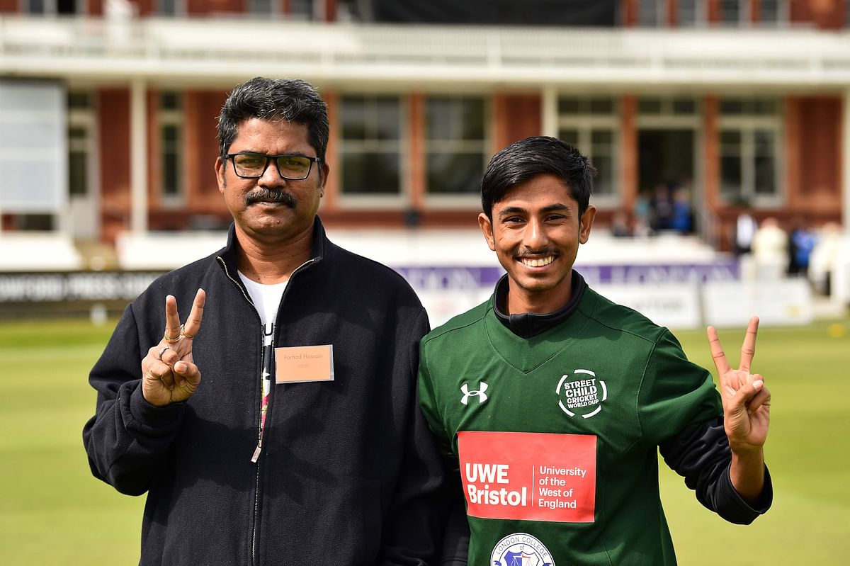 Bangladesh Team Leader Forhad Hossain (L) and Bangladesh player Nizam (R) pose in front of the Lords Pavilion before the Street Child Cricket World Cup Final at Lords Cricket Ground in London on 7 May 2019. Photo: AFP