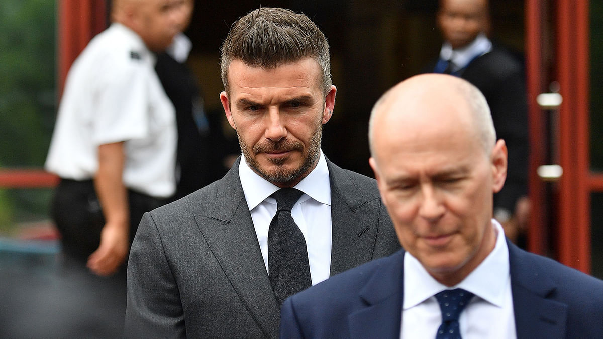 Former England international footballer David Beckham (C) leaves Bromley Magistrates Court in Bromley, south-east of London on 9 May 2019, after being disqualified from driving for six months for driving while using a mobile phone. Photo: AFP