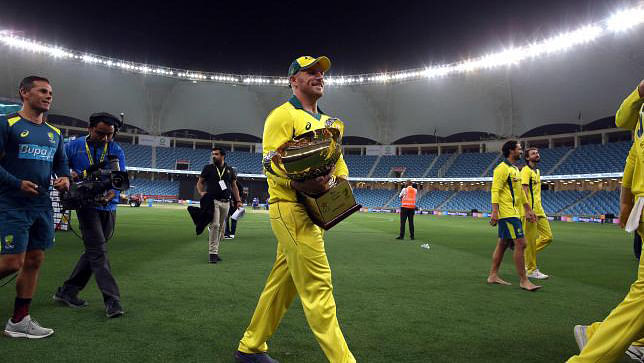 Australian cricketer Aaron Finch carries the trophy after his team won the fifth one day international (ODI) cricket match between Pakistan and Australia at Dubai International Stadium in Dubai on 31 March 2019. Photo: AFP
