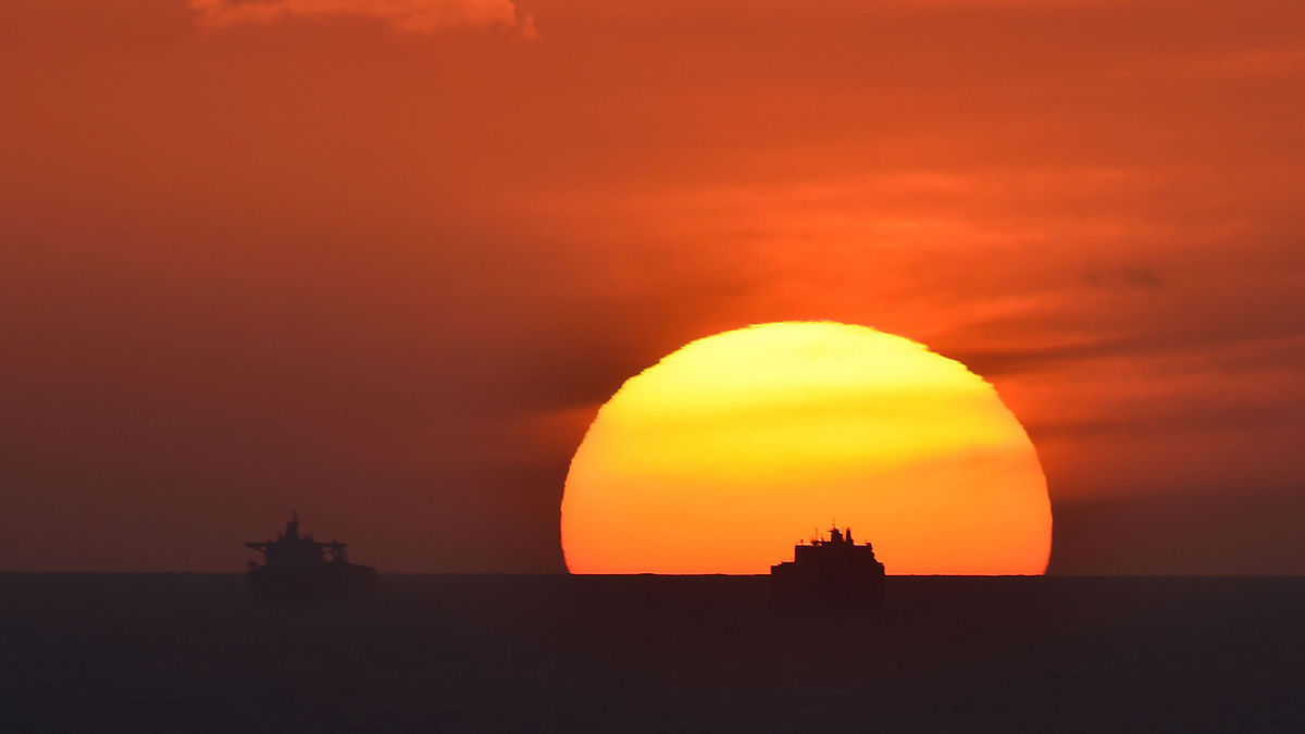 This picture taken on 9 May 2019 shows Saudi cargo ship Bahri Yanbu (R) next to British crude oil tanker Nordic Space at sunset waiting to enter the port of Le Havre. Photo: AFP