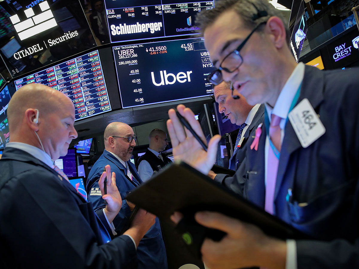 Traders work near the post where Uber is traded on the floor at the New York Stock Exchange (NYSE) in New York, US, on 10 May 2019. Photo: Reuters
