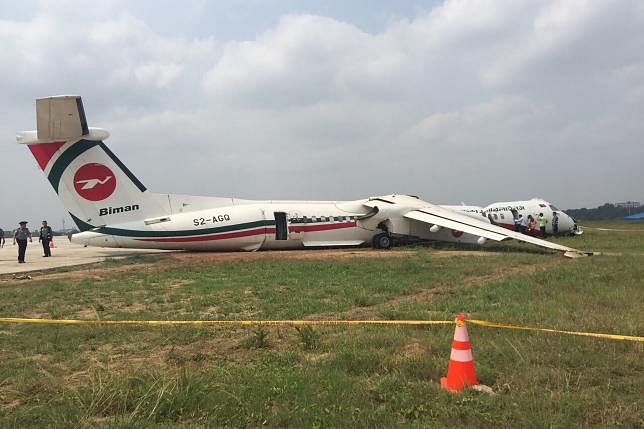 This handout picture taken and released by Myanmar Department of Civil Aviation on 9 May 2019 shows officials inspecting a Biman Bangladesh airlines passenger jet after it slides off a runway at Yangon International airport on 8 May evening. AFP File Photo