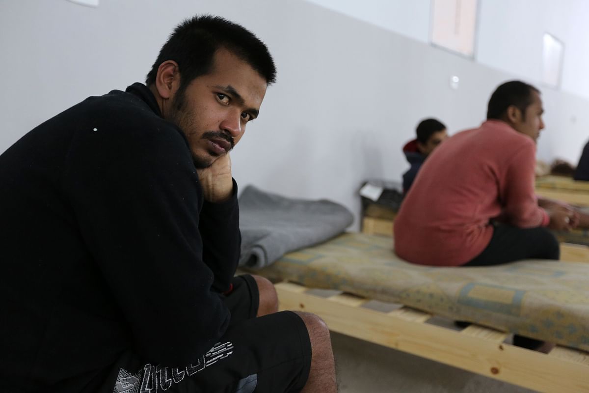 Survivors of a boat carrying migrants that sunk in the Mediterranean during the night of 9 and 10 May, gather at a shelter in the Tunisian coastal city of Zarzis on 11 May 2019. Photo: AFP