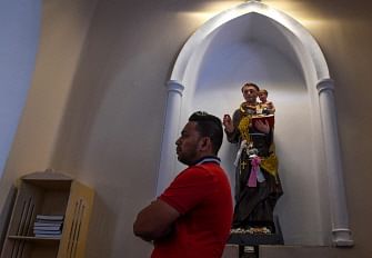 A Sri Lankan Catholic devotee stands as he attends a mass at the St. Theresa`s church as the Catholic churches hold services again after the Easter attacks in Colombo on 12 May 2019. Photo: AFP