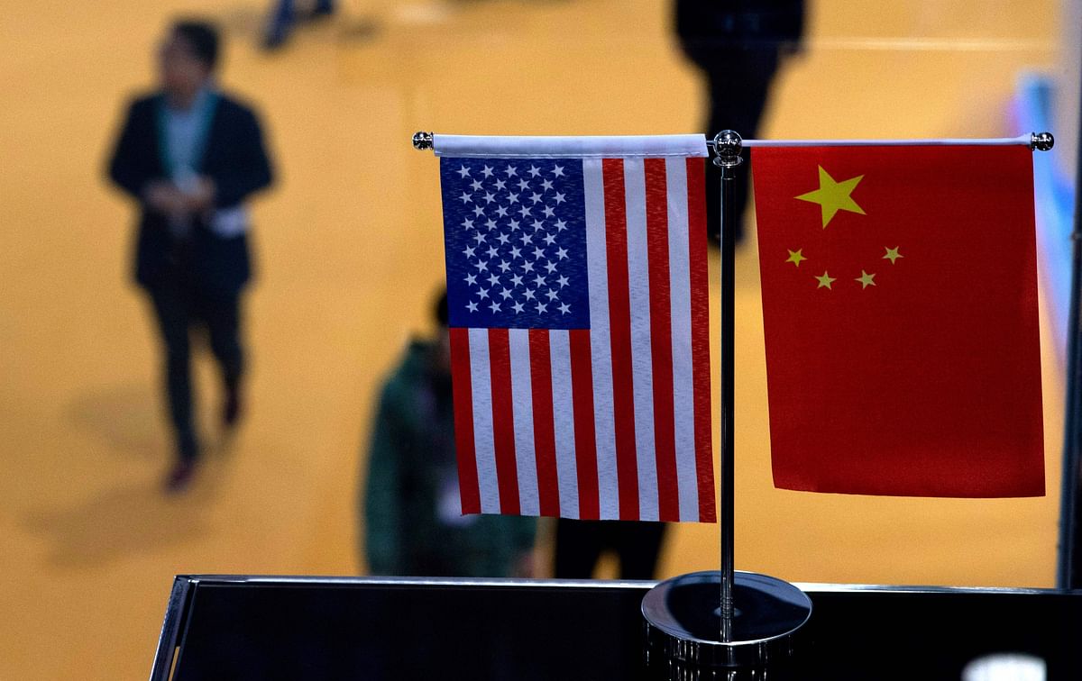 This file picture taken on 6 November 2018, shows a Chinese and US flags at a booth during the first China International Import Expo (CIIE) in Shanghai.