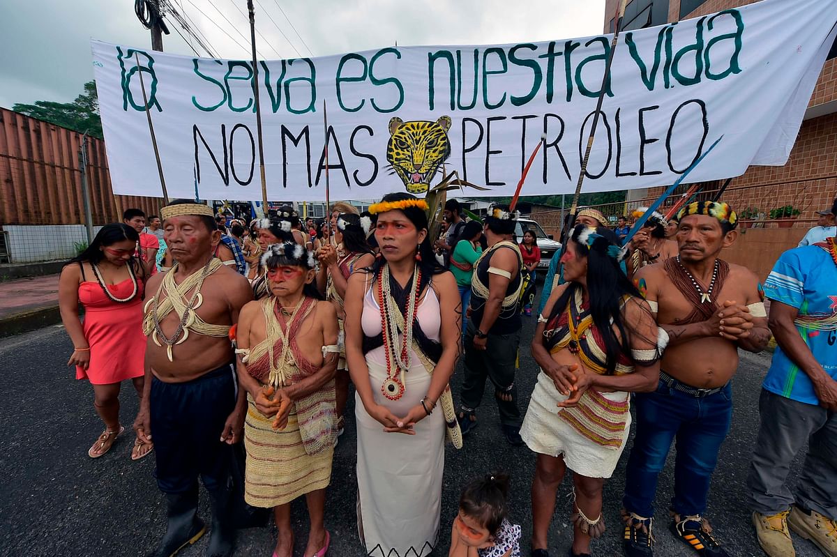 Waorani indigenous people march towards the provincial court to demand the non-exploitation of oil in their territory with a banner reading `The forest is our life. No more oil`, in Puyo, Ecuador, on 11 April, 2019. Photo: AFP