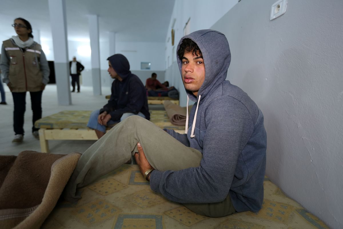 A survivor of a boat carrying migrants that sunk in the Mediterranean during the night of 9 and 10 May, rests at a shelter in the Tunisian coastal city of Zarzis on 11 May 2019. Photo: AFP