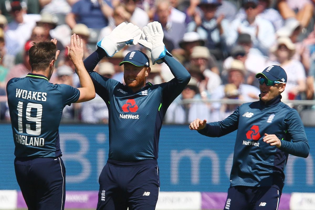 England`s Chris Woakes (L) celebrates taking the wicket of Pakistan`s Babar Azam during the third One Day International (ODI) cricket match between England and Pakistan at The Bristol County Ground, Bristol, southwest England on May 14, 2019. AFP