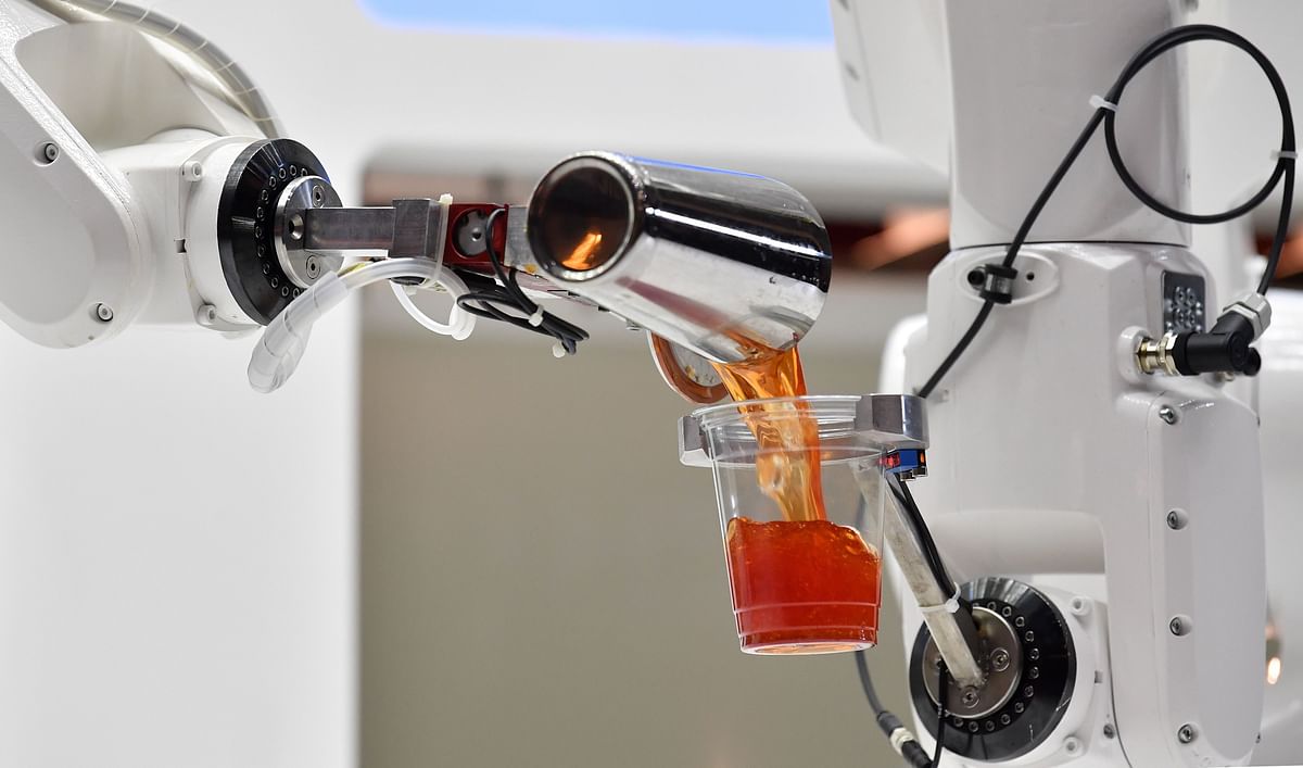 The robotic arms of the Makr Shakr cocktail maker are pictured as they mix a cocktail during a photocall to promote the forthcoming exhibition entitled `AI: More than Human`, at the Barbican Centre in London on 15 May 2019. Photo: AFP