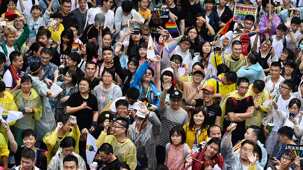 Gay rights supporters celebrate outside Parliament after lawmakers legalised same-sex marriage bill in Taipei on 17 May. Photo: AFP