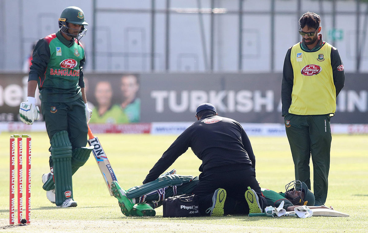 Bangladesh`s Shakib Al Hasan (C) lays on the pitch injured before retiring during the Tri-Nation Series, one-day international between Ireland and Bangladesh at the Malahide cricket club, in Dublin on 15 May 2019. Photo: AFP