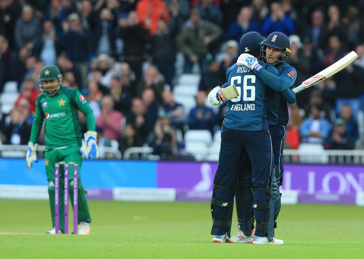 England`s Jason Roy (R) celebrates his century with England`s Joe Root during the fourth One Day International (ODI) cricket match between England and Pakistan at Trent Bridge in Nottingham on 17 May 2019. Photo: AFP