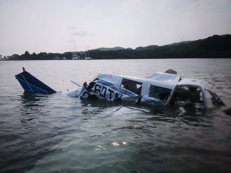 This handout picture shows Honduran firefighters at the site of an accident where a light plane crashed into the sea at the Isla Bonita Area, in Roatan, Honduras on 18 May. Photo: AFP