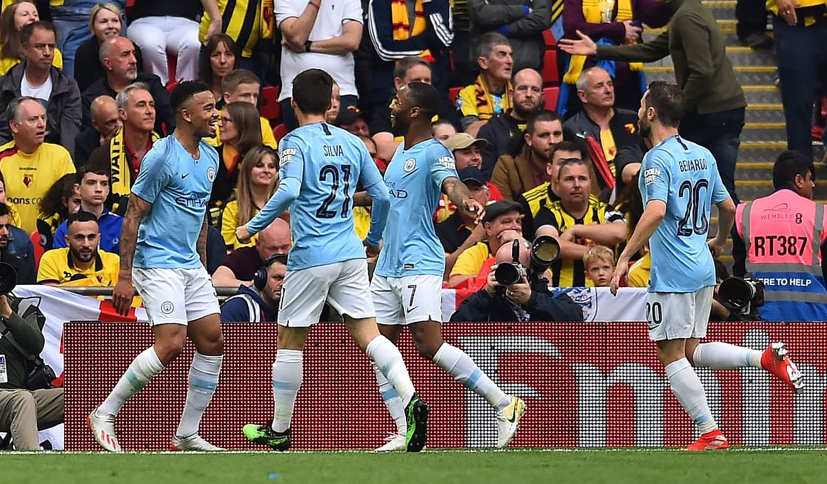 Manchester City`s Brazilian striker Gabriel Jesus (L) celebrates with Manchester City`s Spanish midfielder David Silva (2L), Manchester City`s English midfielder Raheem Sterling (2R) and Manchester City`s Portuguese midfielder Bernardo Silva after he scores the team`s second goal during the English FA Cup final football match between Manchester City and Watford at Wembley Stadium in London, on May 18, 2019. AFP