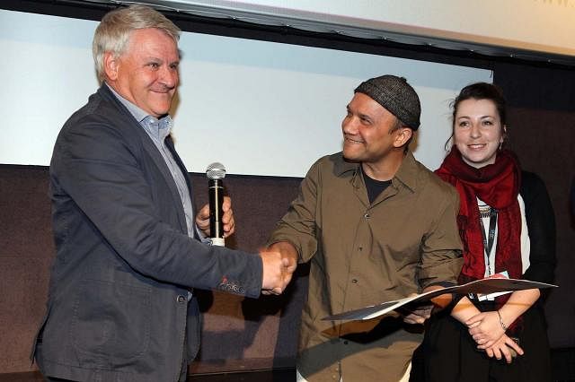 Filmmaker Shaheen Dill-Riaz receives BIM award from jury panel chairman for his documentary `Bamboo Stories` recently. Photo: Collected