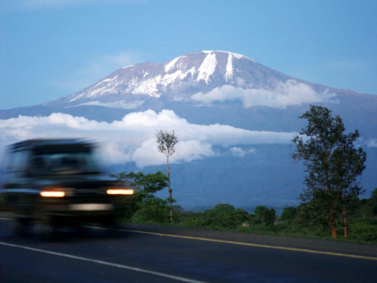 A vehicle drives past Mount Kilimanjaro in Tanzania`s Hie district. Photo: Reuters