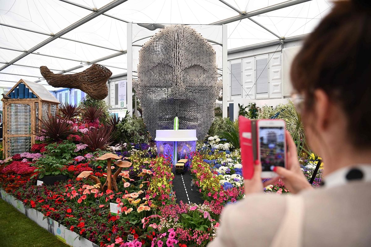 A visitor takes a photograph of a display entitled Floella`s Future, by Baroness Floella Benjamin, during the 2019 RHS Chelsea Flower Show in London on 20 May, 2019. Photo: AFP