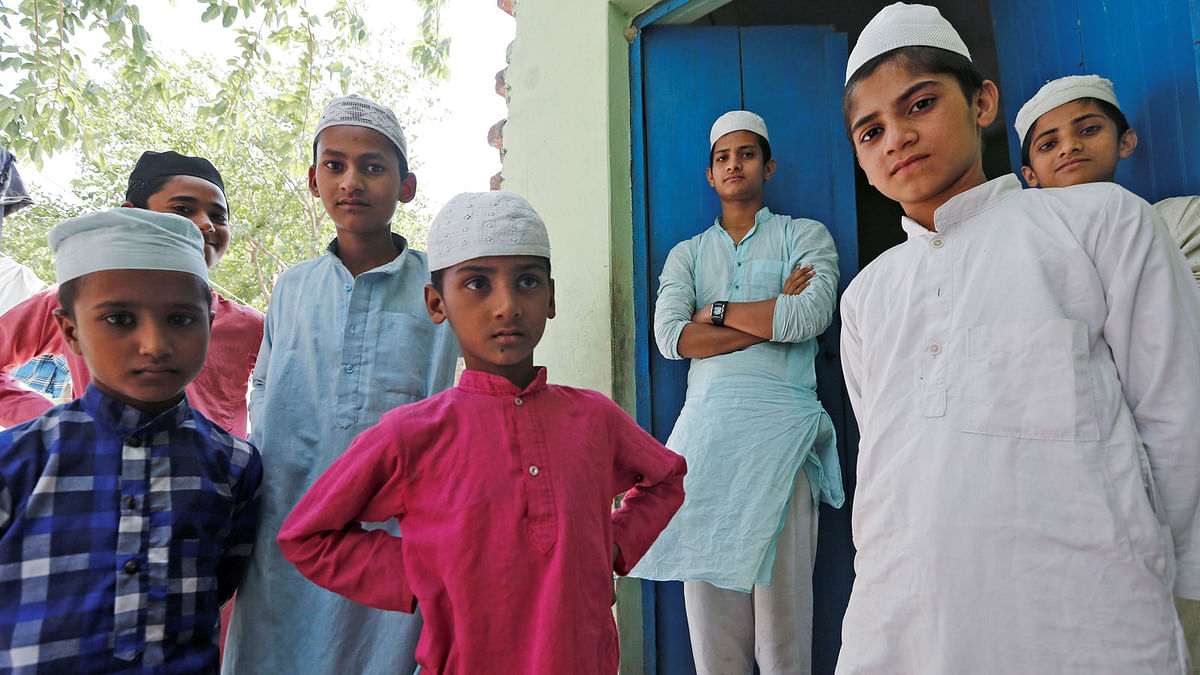 Muslim boys stand during a break inside a madrasa or religious school in the village Nayabans in the northern state of Uttar Pradesh, India on 9 May 2019. Reuters