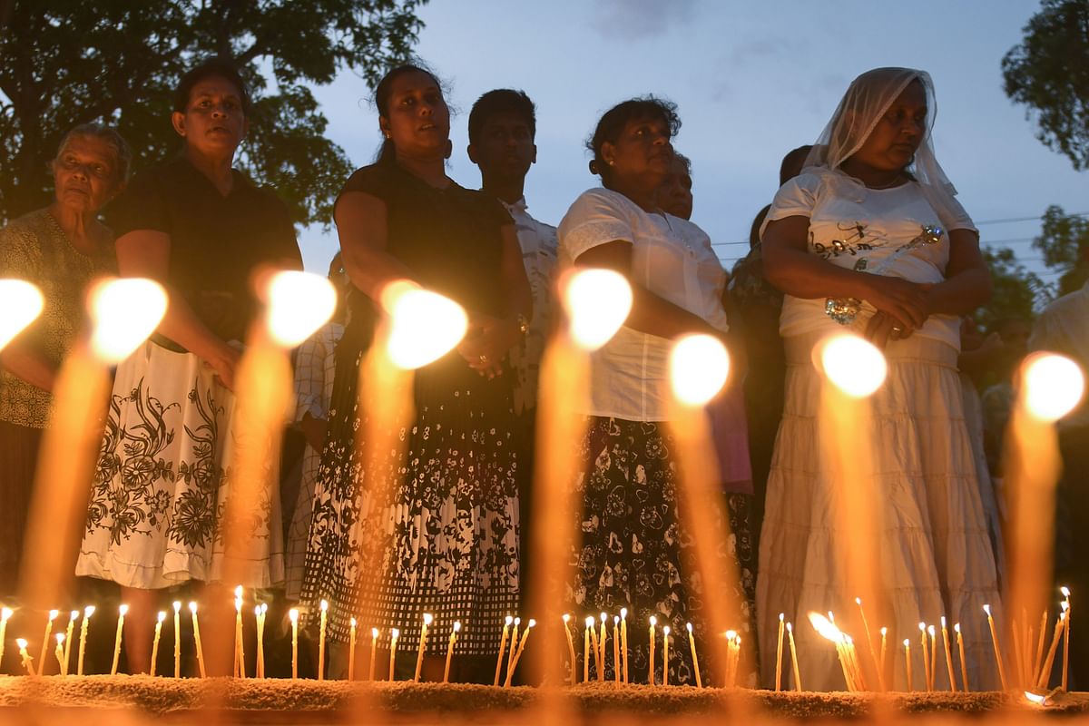 Sri Lankan Christian devotees light candles outside St Sebastian`s Church in Negombo on 21 May a month after Easter Sunday bombings that killed 258 people. Photo: AFP