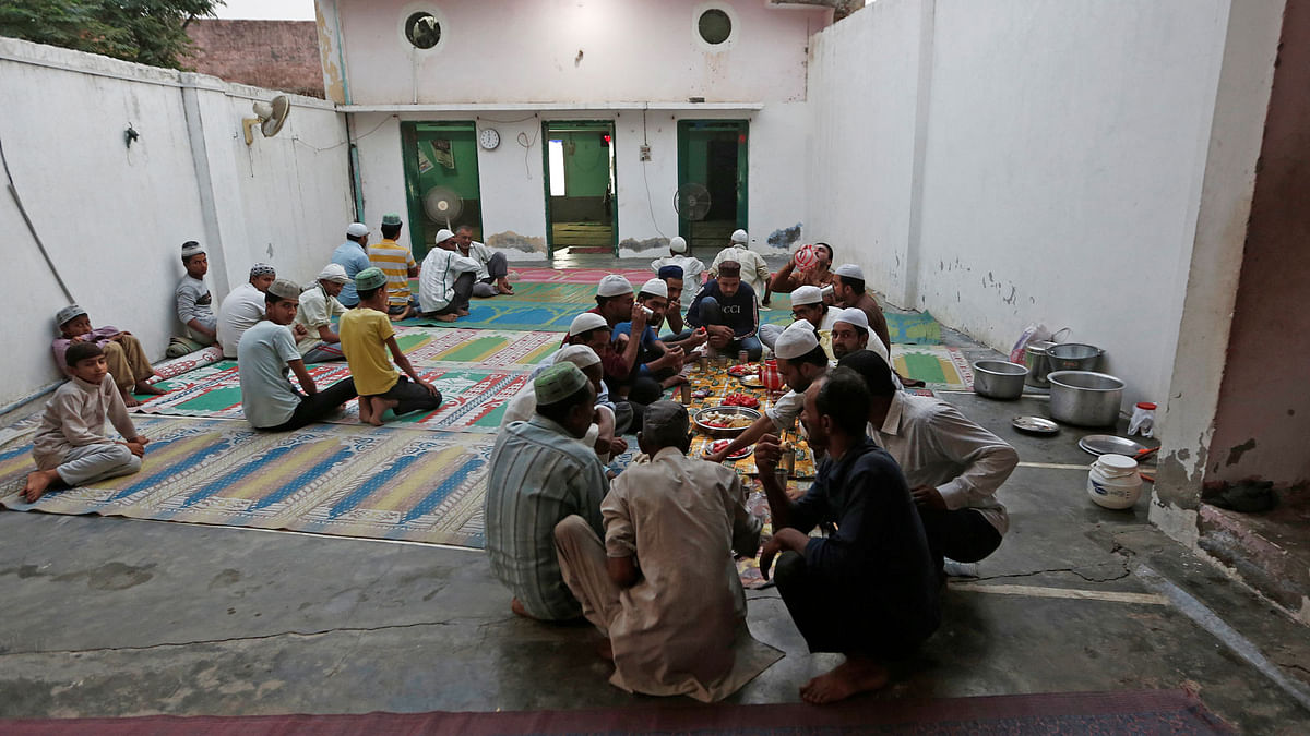 Muslims eat their Iftar (breaking of fast) meal during the holy month of Ramadan inside a madrasa that also acts as a mosque in village Nayabans in the northern state of Uttar Pradesh, India on 9 May 2019. Reuters