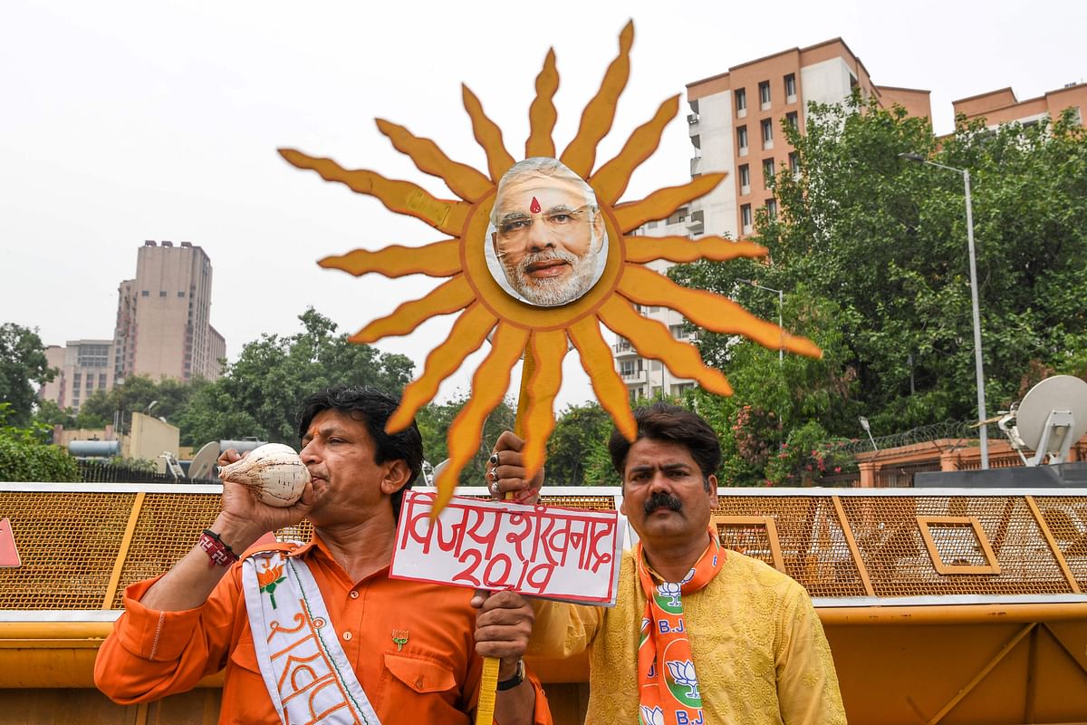 Indian Bharatiya Janata Party (BJP) supporters shout slogans as they celebrate on the vote results day for India`s general election in New Delhi on 23 May. Photo: AFP