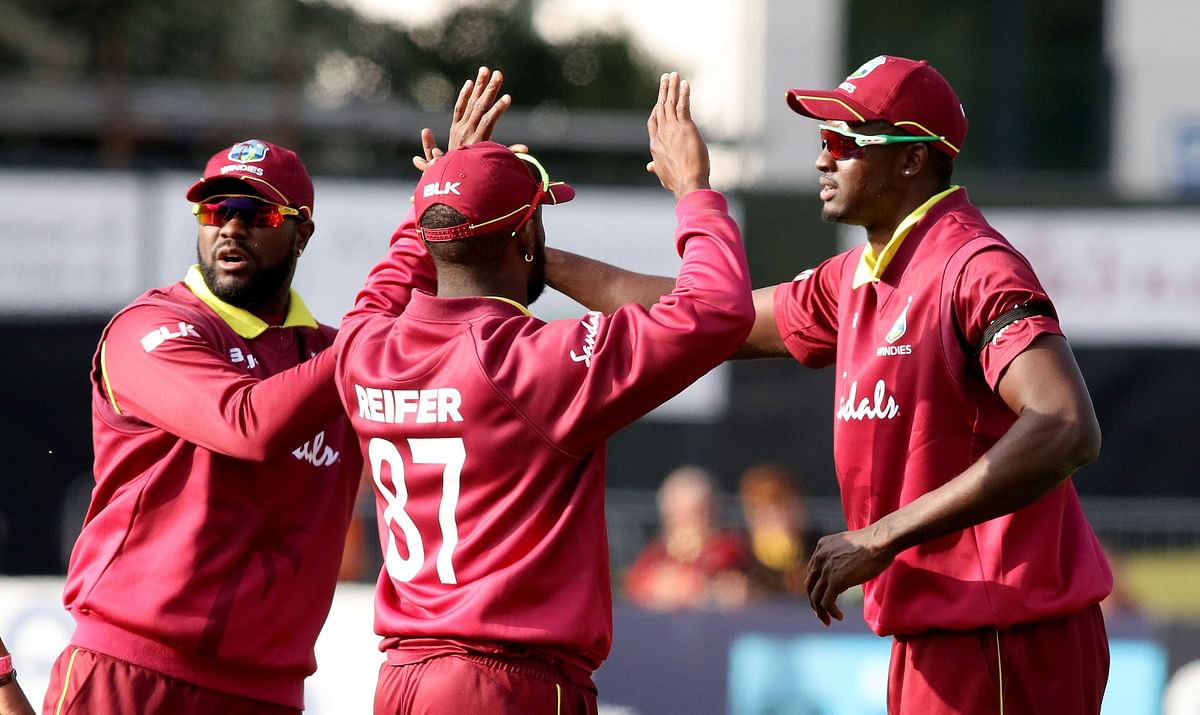 West Indies` captain Jason Holder (R) celebrates with teammates after taking the wicket of Bangladesh`s Tamim Iqbal for 18 runs during the one-day international Tri-Nation Series final between Bangladesh and West Indies at the Malahide cricket club, in Dublin on 17 May 2019. Photo: AFP