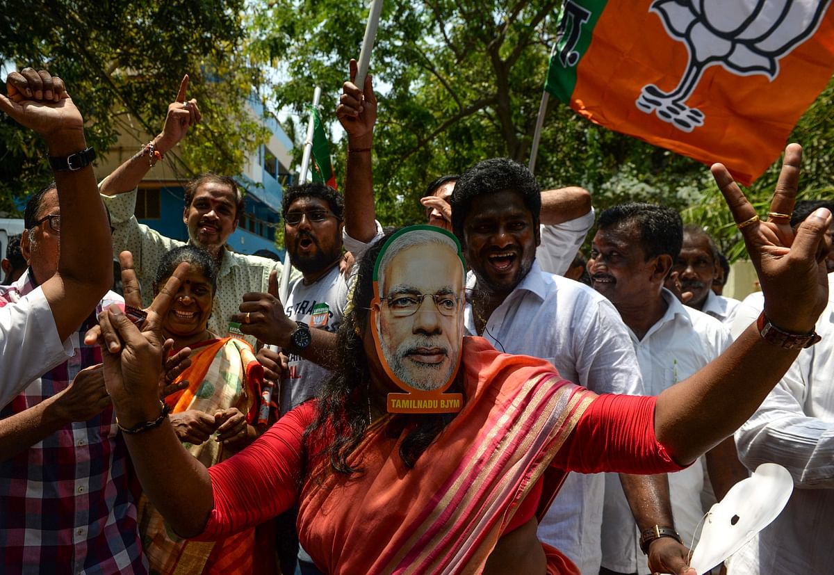 An Indian supporter of Bharatiya Janata Party (BJP) wear a mask of Indian Prime Minister Narendra Modi as she celebrates on the vote results day for India`s general election in Chennai on 23 May 2019. Photo: AFP
