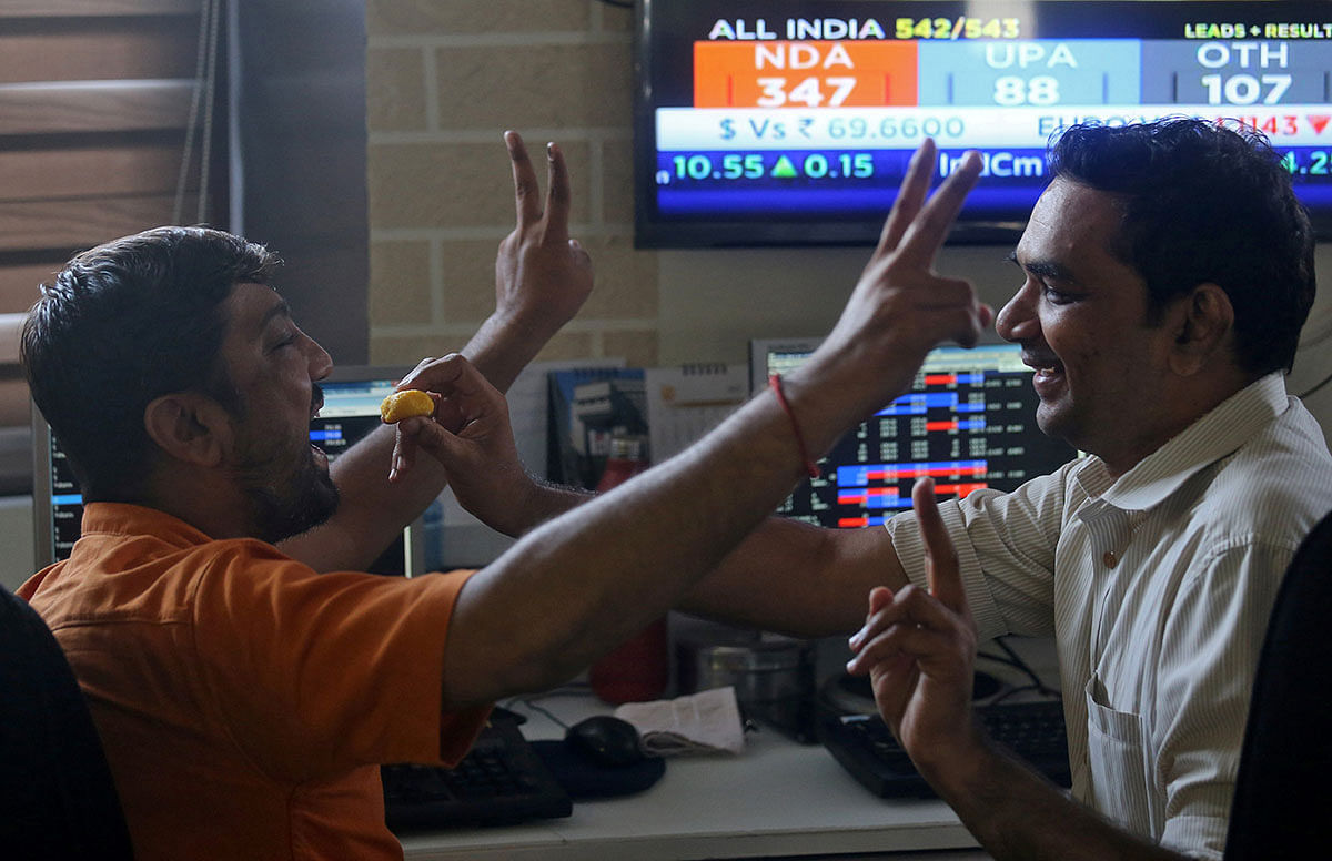 Brokers react after seeing the election result at a stock brokerage firm in Mumbai, India, on 23 May 2019. Reuters
