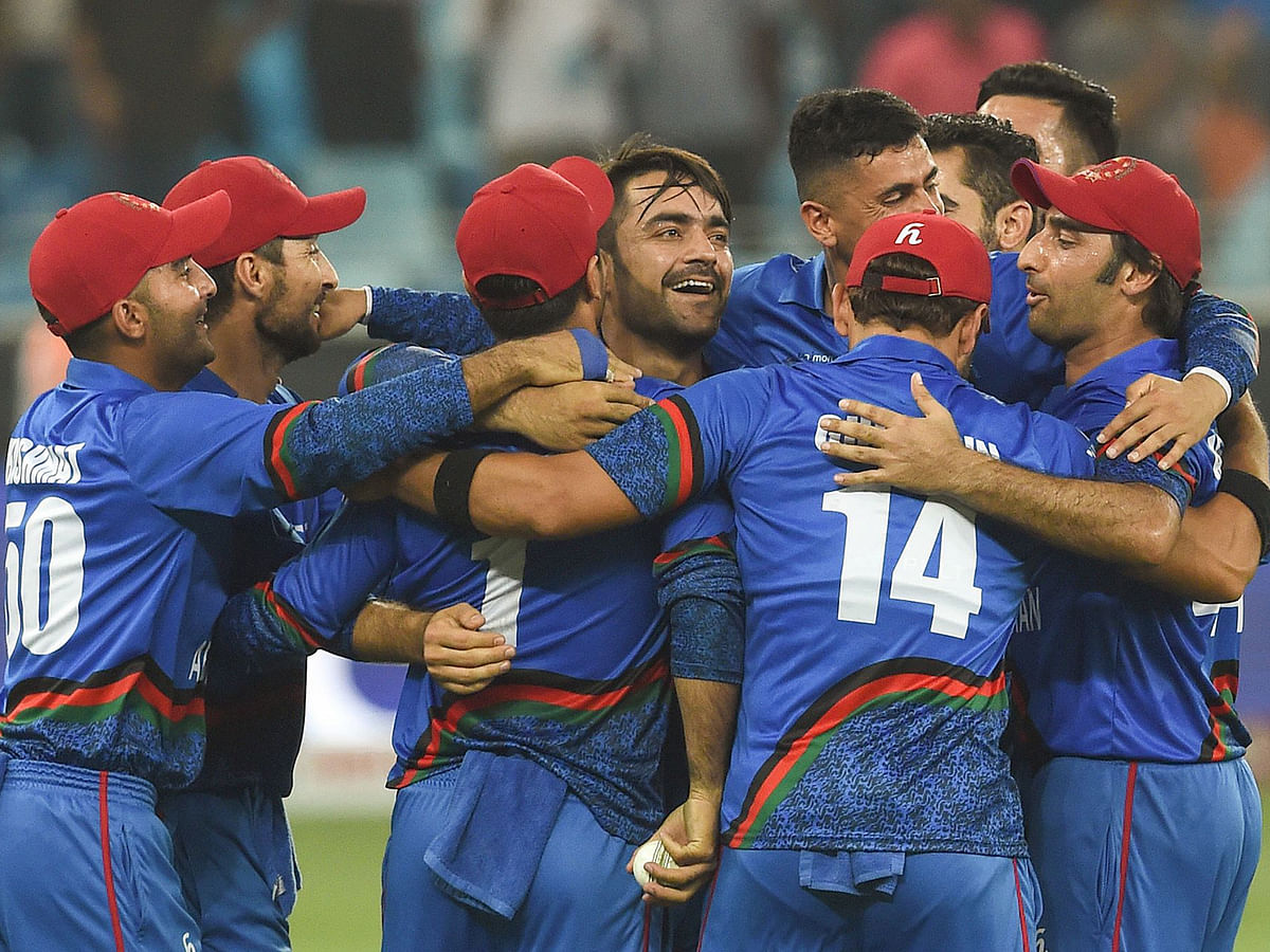 In this file photo taken on 26 September 2018, Afghan cricketer Rashid Khan (C), captain Asghar Afghan (R) celebrates with teammate after Match tied during the one day international (ODI) Asia Cup cricket match between Afghanistan and India at the Dubai International Cricket Stadium in Dubai. Photo: AFP