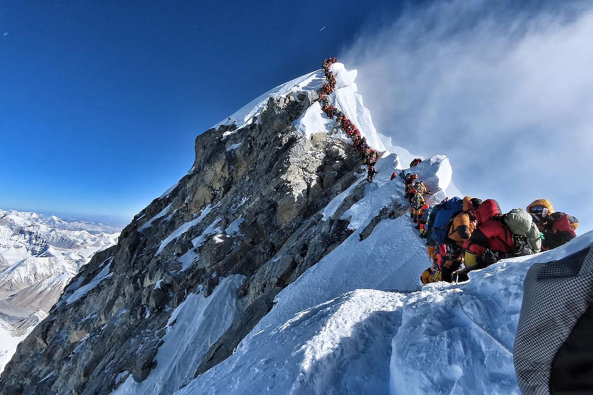 In this file handout photo taken on 22 May, 2019 and released by climber Nirmal Purja`s Project Possible expedition shows heavy traffic of mountain climbers lining up to stand at the summit of Mount Everest. Photo: AFP