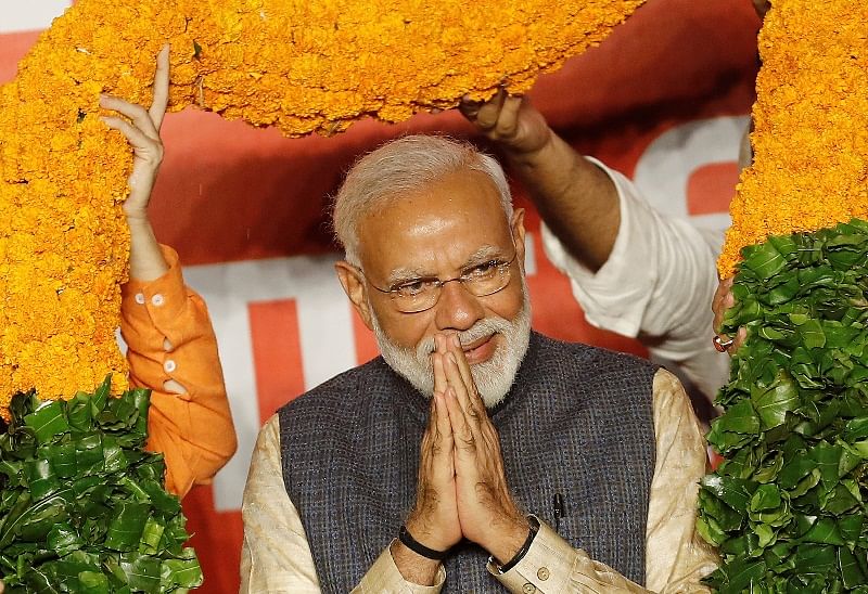 Indian Prime Minister Narendra Modi gestures as he is presented with a garland by Bharatiya Janata Party (BJP) leaders after the election results in New Delhi. Photo: Reuters