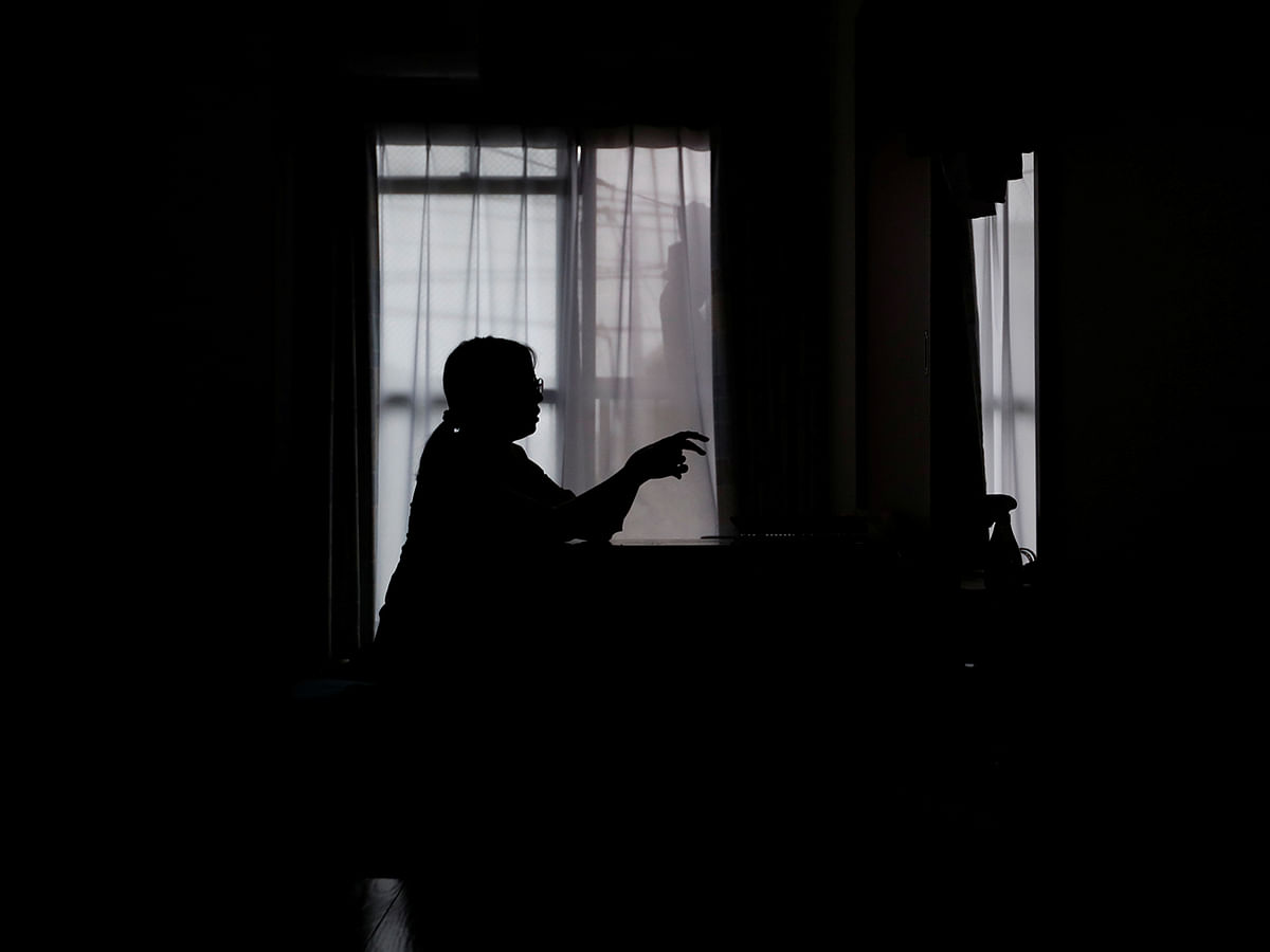 Miwa Moriya is silhouetted while she speaks during an interview with Reuters at her house in Yokohama. Photo: Reuters