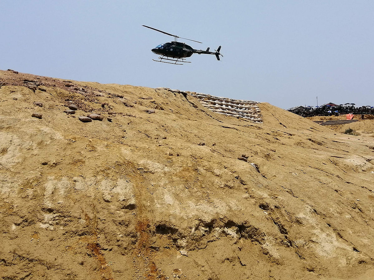 A helicopter flies over the barren hills cleared of trees at a Rohingya refugee camp in Ukhia, during a Bangladesh government disaster management drill, on 23 May 2019. Photo: AFP