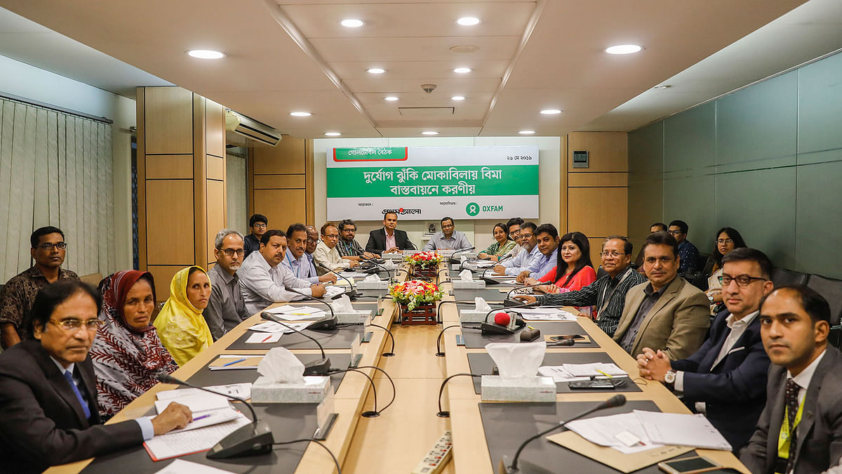 Participants pose for photograph at a roundtable on introducing insurance in disaster risk reduction at Karwan Bazar’s CA Bhaban. Photo: Sabina Yesmin