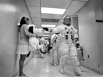 In this 18 May 1969 image obtained from NASA, Apollo 10 Commander Tom Stafford, heading to the Kennedy Space Center launch pad, pats the nose of a stuffed Snoopy held by Jamye Flowers (Coplin), astronaut Gordon Cooper’s secretary. As the sight of planet Earth grew ever smaller, Apollo 10 commander Tom Stafford made an unusual request to mission control. The year was 1969, and his vessel was the first to be equipped with a color camera, which was beaming live images to an awestruck global audience. `I was feeling real high,` Stafford recalled. `I said: `Think you could call over to London and tell the president of the Flat Earth Society that he`s wrong?`` Photo: AFP