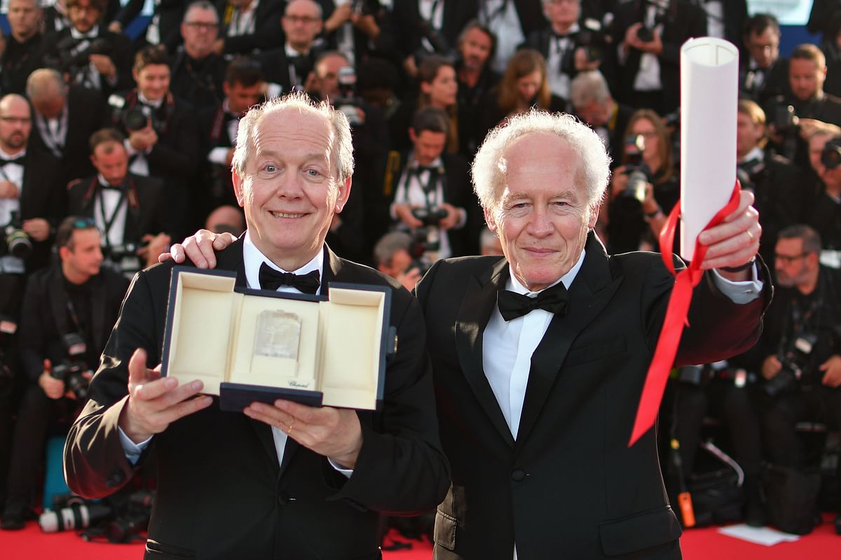 Belgian director Jean-Pierre Dardenne (R) and Belgian director Luc Dardenne pose during a photocall after they won the Best Director prize for the film `Young Ahmed (Le Jeune Ahmed) on 25 May, 2019 during the closing ceremony of the 72nd edition of the Cannes Film Festival in Cannes, southern France. Photo: AFP