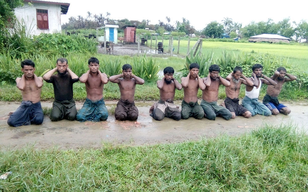 Ten Rohingya Muslim men with their hands bound kneel in Inn Din village, Myanmar on 1 September 2017. Photo: Reuters