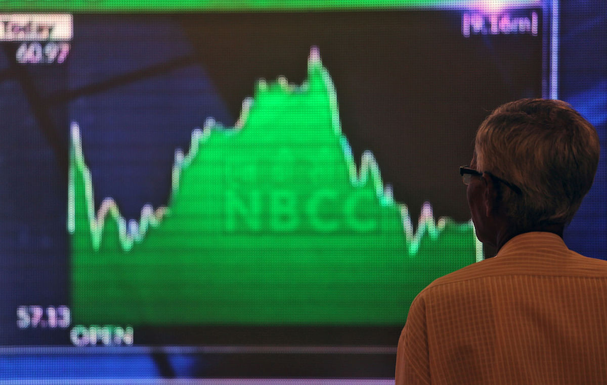 A man looks at a screen displaying news of markets update inside the Bombay Stock Exchange (BSE) building in Mumbai. Photo: Reuters