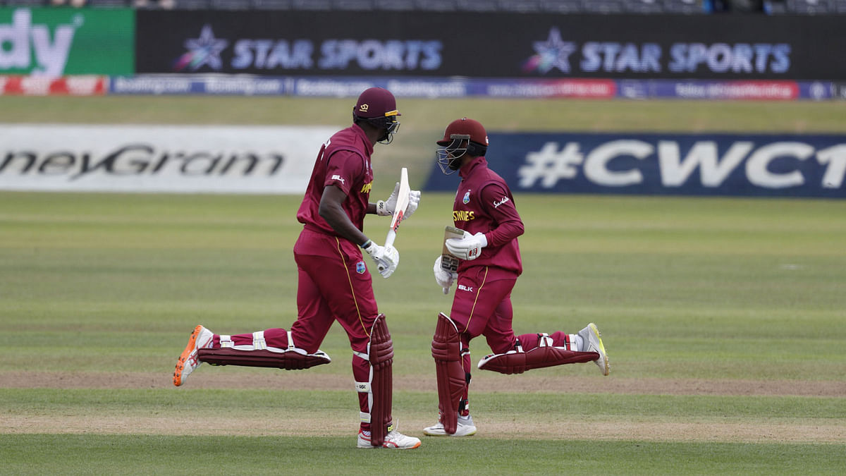 West Indies` captain Jason Holder (L) and West Indies` Shai Hope run between wickets during the 2019 Cricket World Cup warm up match between the West Indies and New Zealand at Bristol County Ground in Bristol, southwest England, on 28 May 2019. AFP